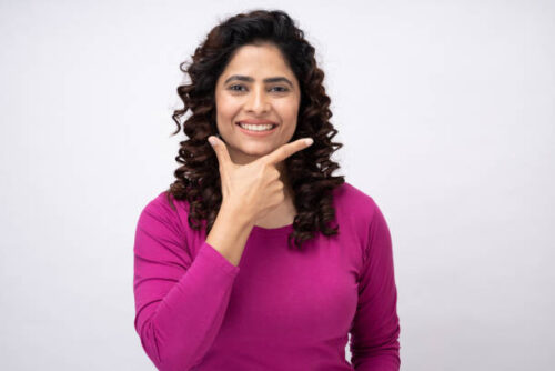 Portrait of sweet girl attractive hairstyle with teeth smiling looking at camera on white background